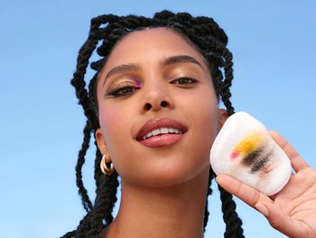 Woman removing her eye makeup with Garnier Micellar Cleansing Water.