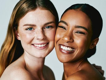 Two friends radiate happiness, their skin refreshed after cleansing with Micellar Water.