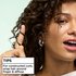 Hair styling tip: woman demonstrating how to wrap hair around a finger and diffuse for perfectly constructed curls using Garnier Fructis mousse.