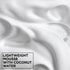 Macro texture shot of lightweight Garnier Fructis hair mousse foam infused with coconut water for hydrating and defining curly hair.