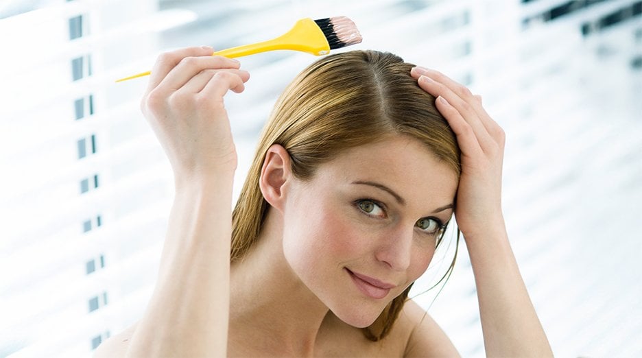 Women dyeing her light brown hair.