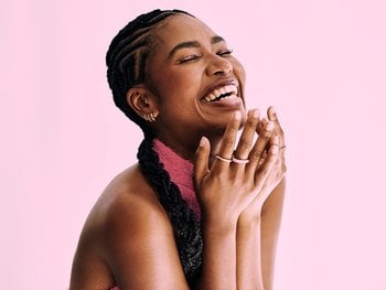 Beauty shot of beautiful black woman in monochromatic pink background