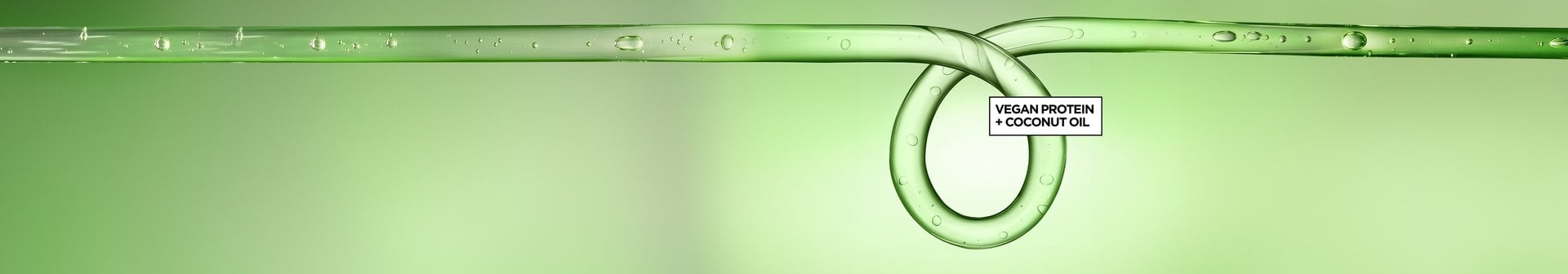 Wide-format promotional hero banner featuring a macro close-up of a translucent green liquid strand stretching horizontally across the frame, adorned with small water droplets along its surface, set against a soft gradient green background. Toward the right-center of the image, the liquid strand loops into a smooth, circular curl shape — visually referencing a defined curl pattern. Centered within the loop is a small black-outlined text box with bold black text reading: "VEGAN PROTEIN + COCONUT OIL," highlighting the key active ingredients of the Garnier Fructis Curl Nourish product line.
