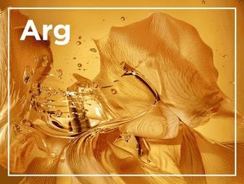 Abstract image of golden, petal-like textures submerged in liquid with bubbles, with the letters "Arg" visible in white.