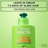 Close-up of a regular sized bottle of Garnier Fructis Sleek & Shine Leave-In Conditioner, with text that claims "Up to 3 days of sleek hair with system of Sleek & Shine Shampoo, Conditioner and Leave-in Cream. For frizzy, dry hair".