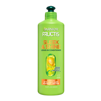 A large green bottle of Garnier Fructis Sleek & Shine Leave-In Conditioner (16.9 FL OZ / 500ml), highlighting "VEGAN KERATIN + ARGAN OIL" and claiming SYSTEM FOR UP TO 3 DAYS SLEEK FOR FRIZZY, DRY HAIR.