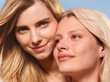 Two people embracing, one touching the other's face.